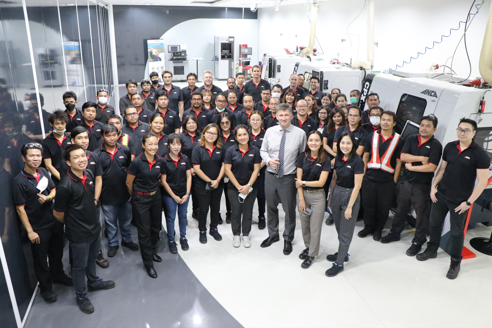 ANCA Group CEO Martin U. Ripple with staff members at an ANCA facility in Thailand.